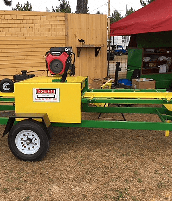 A yellow and green trailer with a red canopy.